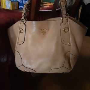 Authentic Prada pebble leather handbag in good condition. Tan